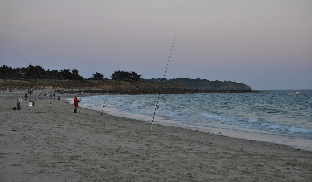 Pêcheurs sur la plage au crépuscule
